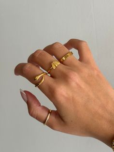 Gold coiled snake ring is adorable and edgy, and a very trendy look for jewelry. Cute serpent snake ring that non-tarnishing - stainless steel and gold - non-tarnishing Socials: Insta: @vasi.jewelry  Site: http://vasijewelry.com Tik Tok: vasi.jewelry Care - protect your jewelry from things that could scratch the surface - keep away from harsh chemicals - store jewelry away from the sun and in a microfiber pouch - clean your pieces with warm water and detergent-free soap and thoroughly dry - poli Gold Minimalist Snake Ring For Promise, Gold Minimalist Snake Ring As Promise Ring, Handmade Gold Snake Ring, Gold Minimalist Snake Ring For Gift, Gold Minimalist Snake Ring, Minimalist Snake Ring As A Gift, Rings Simple Everyday, Chicago Beats, Dainty Ring Stack