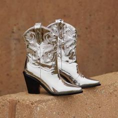 Billini Sergio Silver Chrome Pointed-Toe Western Boots Color.Silver Size: 9 Man-Made Upper, Man-Made Lining, Man-Made Sole. Imported. 3" Stacked Angled Heel. Lightly Cushioned Insole. Rubber Sole Has Nonskid Markings No Box Glamorous Metallic Silver Pointed Toe Boots, Silver Western Boots With Snip Toe, Silver High Heel Boots With Reinforced Heel, Elegant Silver Snip Toe Boots, Glamorous Silver Pointed Toe Boots, Silver Ankle Boots For Fall, Glamorous Silver Boots With Reinforced Heel, Chic Silver High Heel Boots, Chic Silver Boots For Fall