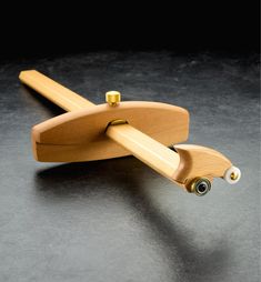 a pair of wooden skateboards resting on top of each other in front of a black background