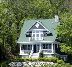 a white and black house surrounded by trees