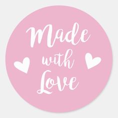 a round sticker with the words made with love in white on a pink background