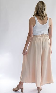 Be the talk of every room with our Keep it Glowing - Woven Wide Leg Pants! These champagne, satin pants are beyond gorgeous. They give the illusion of a skirt, but bring the comfort of pants. This item has a high waist, elastic waist band, and pockets. We love these so much because you can throw on a blouse to dress them up, or a tank to dress them down. You can wear these for any occasion and be the most stylish gal in the room! - Champagne colored woven wide leg pants - High waist - Elastic wa Spring Flowy Skirt Bottoms, Wide-leg Pants With Elastic Waistband For Daywear, Elastic Waistband Bottoms For Daywear, Wide Leg Bottoms With Elastic Waistband For Daywear, Elastic Waistband Wide Leg Pants For Daywear, Loungewear Bottoms With Elastic Waistband In Rayon, Beige Bottoms With Elastic Waistband, High Waist Bottoms With Wide Waistband For Daywear, Stretch Wide Leg Bottoms For Daywear