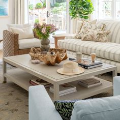 a living room filled with furniture and a large window covered in lots of windowsills