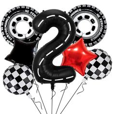 the number two balloon is surrounded by black and white balloons with red foil stars on them