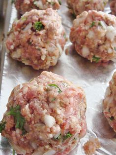 some meatballs are sitting on a sheet of tin foil and ready to be eaten