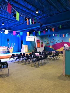 an empty stage set up for a children's birthday party with chairs and decorations