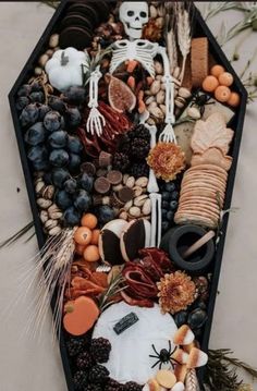 an arrangement of halloween food and decorations in a hexagonal tray on a table