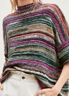 a woman wearing a multicolored knitted sweater with text overlay that reads, romazza lanacrossa