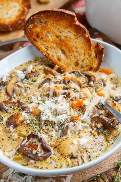 a bowl of soup with bread on the side