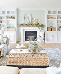 a living room filled with furniture and a fire place in the middle of a room