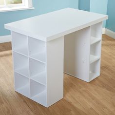 a white desk and bookcase in a room with blue walls, hardwood floors and hard wood flooring