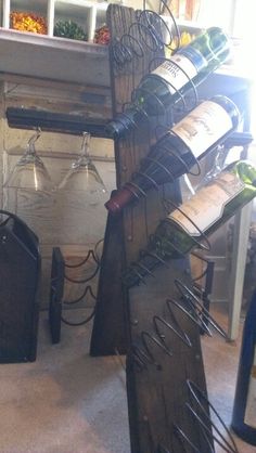 a wine rack with several bottles and glasses on it