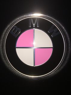 the bmw logo is shown in black and pink