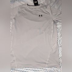 Elevate Your Workout Gear With This Brand New With Tags, Under Armour Heatgear Compression Tee. Designed For Men In Size 2xl, This Solid Gray Tee Features Short Sleeves, A Crew Neckline, And A Pullover Closure For Ease Of Wear. The Lightweight, Moisture Wicking And Breathable Fabric Make It Perfect For All Seasons. This Under Armour Tee Also Boasts Moisture-Wicking Technology To Keep You Dry And Comfortable. The Collarless Design, Stretch Material, And Tagless Feature Add To The Modern And Sleek Under Armour Fitted Moisture-wicking Tops, Fitted Under Armour Moisture-wicking Top, Under Armour Crew Neck Top, Under Armour Sporty Shirt For Sports, Sporty Under Armour Shirt For Sports, Sporty Under Armour Sports Shirt, Under Armour White Moisture-wicking Top, Under Armour Gray Crew Neck Top, Under Armour Relaxed Fit Crew Neck Top