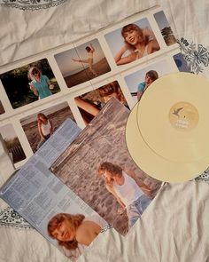 there is a white record and pictures on the bed