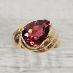 L-2177  Vintage Pink Tourmaline 14K Yellow Gold Ring 7 Solitaire Luxury Design Pretty  AMAZING VINTAGE HEFTY SOLID 14K GOLD PINK TOURMALINE TEARDROP SOLITAIRE RING. WEAR ALONE ON WITH YOUR STACK. WONDERFUL COLOR & HIGHEST QUALITY. JUST PART OF MY MOST RECENT ESTATE FINDS! FOLLOW ME TO SEE THEM ALL!    Metal: 14K Yellow Gold Metal Purity: 14K Material:  Ring Size: 7 Other Dimensions: 1/2"W Form: Solitaire Ring Luxury Age: Vintage Weight (Grams): 7.6 IT IS IN EXCELLENT ESTATE CONDITION  ALL ITEMS Luxury Tourmaline Solitaire Jewelry, Red Tourmaline Fine Jewelry Rings, Yellow Gold Tourmaline Cabochon Ring, Vintage 14k Gold Multi-stone Ruby Ring, Pink Tourmaline Cabochon Ring, Ring Luxury, Yellow Gold Ring, Pink Tourmaline, Solitaire Ring