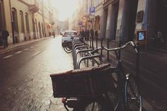 a bike parked on the side of a street next to a row of parked cars