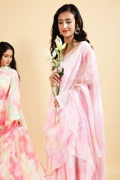 Baby pink pre-draped printed saree with ruffle trim at the border. Comes with sequin embroidered blouse.
Component: 2
Pattern: Print and Embroidery
Type Of Work: Sequin
Neckline: Square
Sleeve Type: Cap
Fabric: Organza Satin
Color: Pink
Other Details: 
Low back with tie up and tassels
Closure: Back hook
Note: The saree worn by the model on the left is not for sale
Occasion: Destination Wedding - Aza Fashions Print And Embroidery, Ruffle Saree, Drape Saree, Printed Saree, Blouse For Women, Satin Color, Fashion App, Pink Sequin, Saree With Blouse