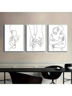 three black and white paintings hanging on the wall