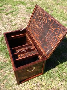 an open wooden box sitting in the grass