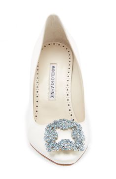 a pair of white high heels with blue crystals on the heel and an embellished buckle