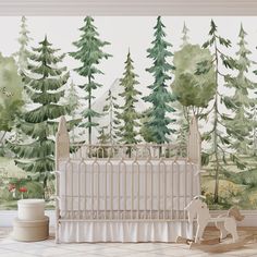 a baby crib in front of a forest mural