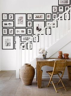 an image of a room with pictures on the wall and a table in front of it