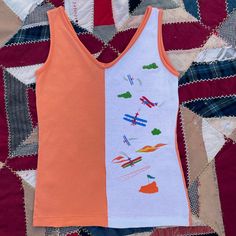 "Available  Vintage 80s 90s orange and white two tone tank top with airplane graphics  Super cute top 😍 Marked size small  Retro style  Best fit small medium  Pit to pit 15\" length 23\" Shipping is $6 #vintage #top #retro #80s #small" Retro Graphic Print Cotton Top, Retro Yellow Tops With Vintage Print, Casual Orange Cotton Vest, Vintage Orange Top With Retro Print, Retro Orange Sleeveless Top, Spring Retro Graphic Print Tank Top, Retro Multicolor Tank Top, Top Marks, Retro Tops