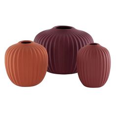 three vases in different colors on a white background