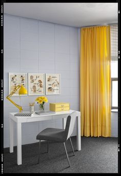 a white desk and chair in a room with yellow curtains