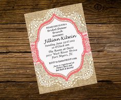 the wedding card is displayed on top of a wooden table with woodgrain and burl