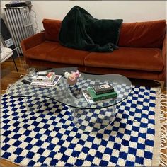 a living room with a couch, coffee table and rug