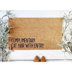 a door mat that says complimentry cat hair with entry