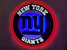 the new york giants neon sign is lit up in red, blue and purple colors