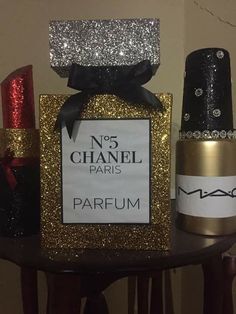 a bottle of nail polish next to a box with a sign that says no 5 chanel paris parfum