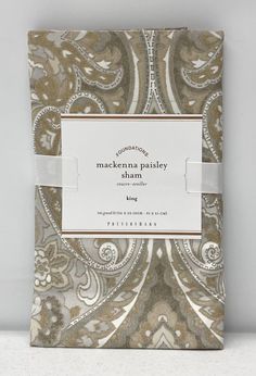 the packaging for mackenna paisleyy sham is shown in gold and white colors