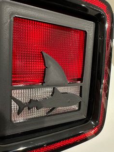 the tail light of a car with a shark on it