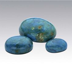 three blue stones sitting next to each other