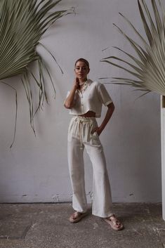 Upgrade your summer wardrobe with our organic cotton two-piece set. Made with sustainability in mind, this set offers both comfort and style. Pair it with our linen short sleeve shirt for a breezy and effortless look. Explore our collection of linen women's sets, perfect for embracing the boho style. Whether you're going on a summer holiday or simply enjoying the warm weather, our linen clothing line has you covered. Stay chic and comfortable with our summer holiday clothes designed for women wh Relaxed Summer Loungewear Sets, Bohemian Cotton Sets With Short Sleeves, Relaxed Loungewear Sets For Summer, Summer Relaxed Loungewear Sets, Cotton Wide Leg Sets With Relaxed Fit, White Linen Summer Sets, Casual Linen Sets For Vacation, Beige Cotton Sets With Relaxed Fit, Sustainable Fashion Cotton Bottoms For Summer