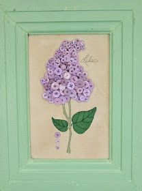 a painting of purple flowers in a green frame