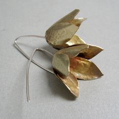 These statement earrings are made of brass, a bluebell flower just a little bit open, and a long stem in silver. The style is modern, minimal, and clean, and the manual cut adds value to every single pair, they follow the trend of fashion that wants big and showy earrings. Despite the dimensions are very light and very pleasant to wear even every day They weigh each 0.15 oz A total length of 2 " Maximum width of 1". Thank you for the visit, follow me on Instagram; @Petrahjewelry come on Facebook Silver Flower-shaped Brass Earrings, Silver Brass Flower Earrings, Delicate Silver Brass Earrings, Handmade Minimalist Flower Shaped Earrings, Handmade Minimalist Flower Earrings, Handmade Minimalist Flower-shaped Earrings, Minimalist Flower-shaped Earrings, Sculptural Earrings, Bluebell Flower