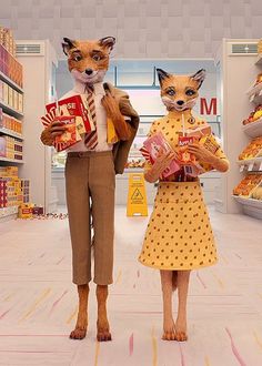 two foxes are standing in a grocery store holding boxes and bags with food on them