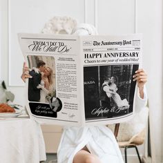 a woman sitting in a chair holding up a newspaper to her face with the words happy anniversary written on it