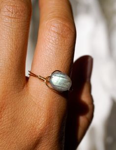 A simple, magical, elegant 14k gold-filled wire-wrapped ring featuring an oval shaped grade A labradorite bead imported from Japan. Discover yourself with the power of labradorite and its connection to mystical lore and ancient legends - it is said that this gemstone is a crystal that can be traced back to the native tribes in icy Canada, created from frozen fire which is a result of the northern lights. Its iridescent blues, greens, yellows reminds us of the magic in the spirit world while also Delicate Wire Wrapped Jewelry, Oval Hand Wrapped Rings As A Gift, Oval Hand Wrapped Rings For Gift, Wire Wrapped 14k Gold Filled Rings Perfect For Gifts, Elegant Everyday Wire Wrapped Rings, Handmade Minimalist Oval Crystal Ring, Minimalist Hand Wrapped Crystal Ring Gift, Wire Wrapped 14k Gold Filled Rings As Gift, 14k Gold Filled Wire Wrapped Rings As Gifts