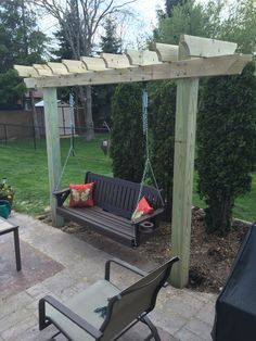 a wooden bench sitting under a pergoline covered arbor