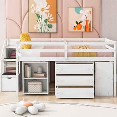 a white bunk bed sitting next to a desk with drawers on top of it in a room