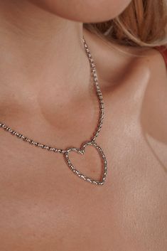 Translated from Italian, ‘Amore’ means love, and it’s a sentiment that we always like to express through beautiful, handcrafted pieces. The Amore Collection features a heart shape entirely crafted from our signature Links chain in 2mm diameter. Refined and romantic, these pieces are timeless symbols of love and romance. ​​The iconic DelBrenna texture makes them fresh and original. The Amore necklace is an ideal gift for someone special in your life, or just for yourself, representing your unique Elegant Silver Necklace With Heart Detail, Sterling Silver Heart Pendant Necklace For Parties, Silver Open Heart Necklace For Party, Open Heart Necklace For Valentine's Day Party, White Gold Heart Necklace For Party, Valentine's Day Open Heart Necklace For Party, Heart Beads Heart-cut Necklace For Party, Heart Cut Heart Beads Necklace For Party, Party Heart Cut Necklace With Heart Beads