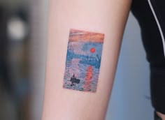 a woman's arm with a small painting on the left side of her arm