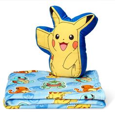 a blanket and pillow with a pikachu character on it sitting next to each other