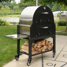 an outdoor bbq grill with firewood stacked on it